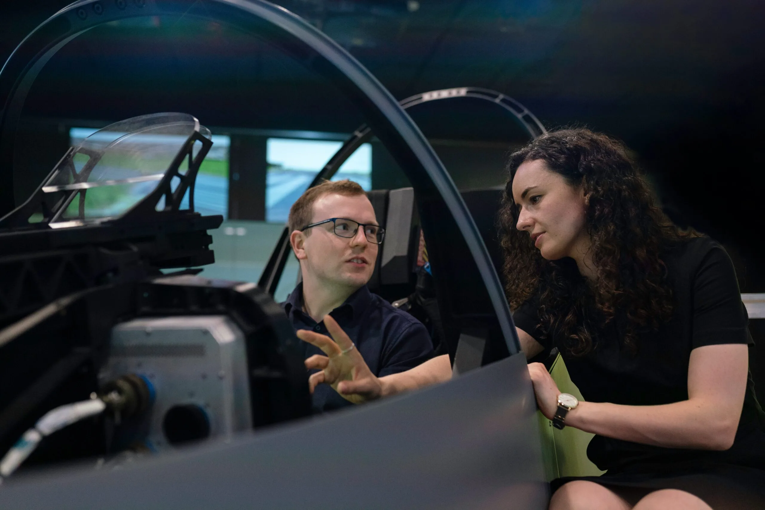 Engineers reviewing systems in a flight simulator
