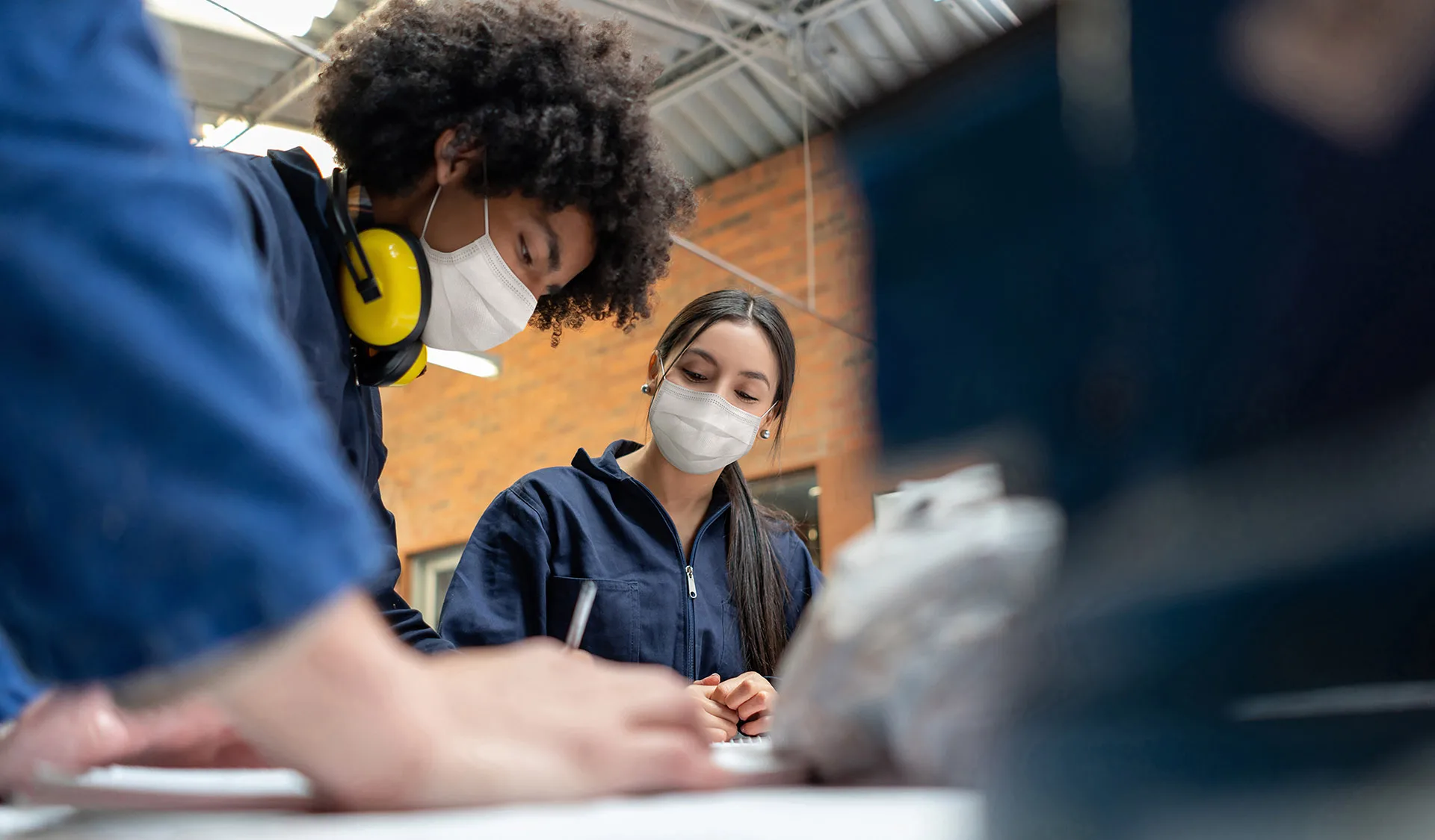 A team collaborating around a workshop bench