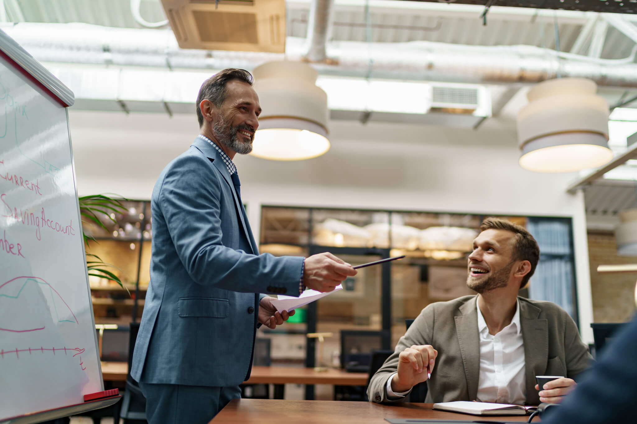 A leader facilitating a working session with a colleague