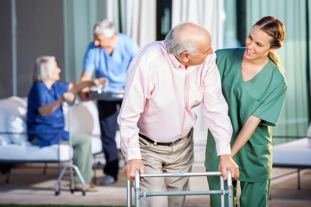 Home health care worker assisting an elderly patient
